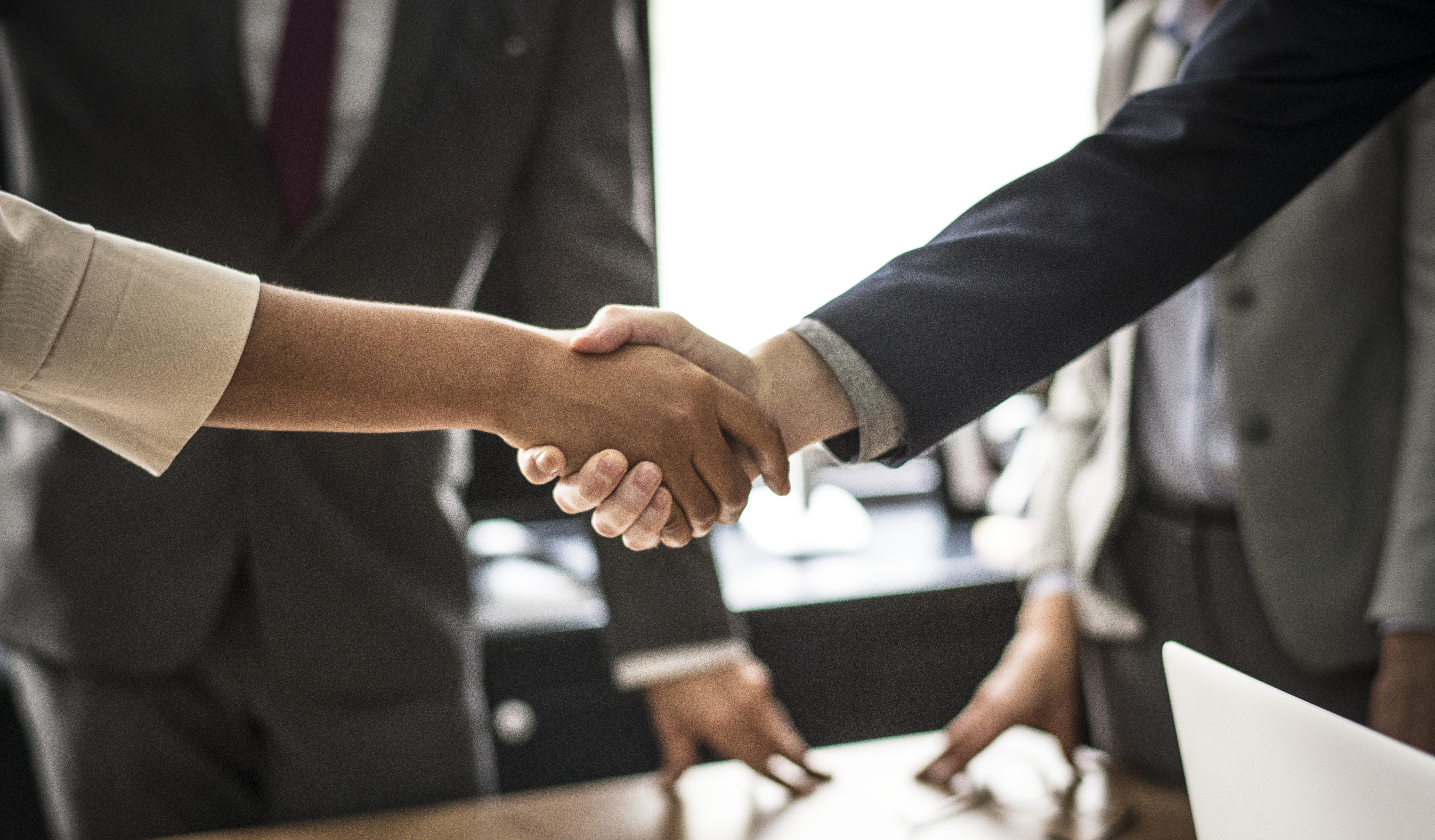 business-people-shaking-hands-meeting-room